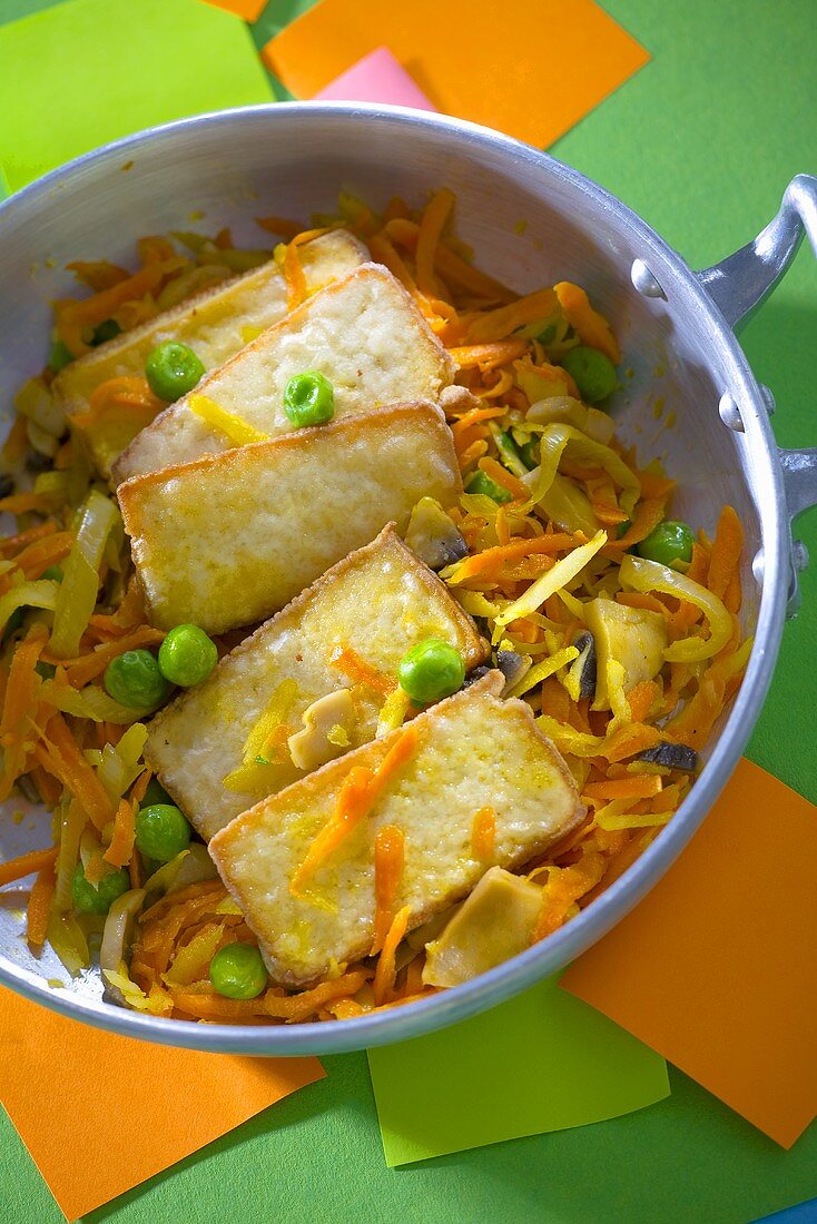 Fried tofu slices on vegetables