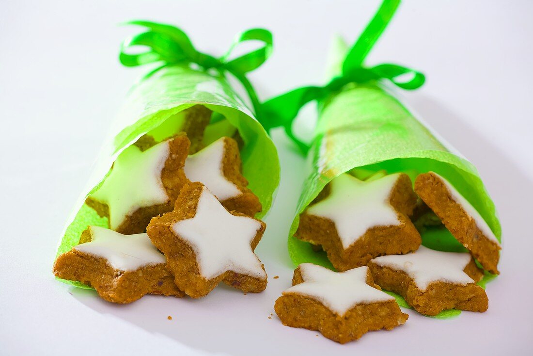 Star-shaped walnut biscuits in green paper cones