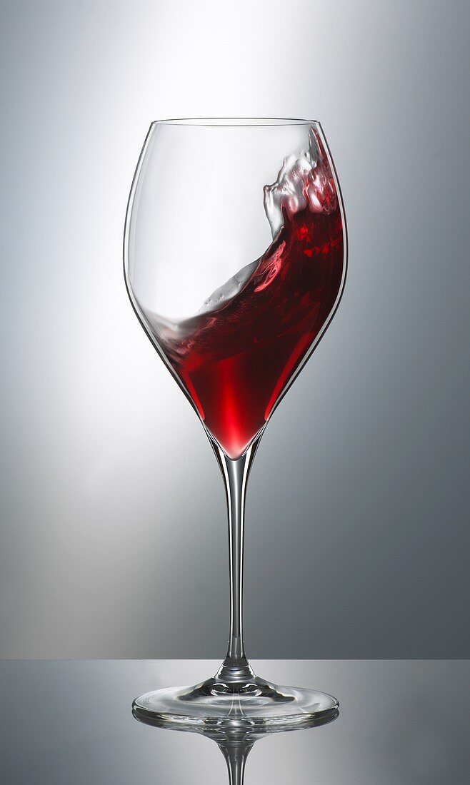 Red wine swirling in a glass