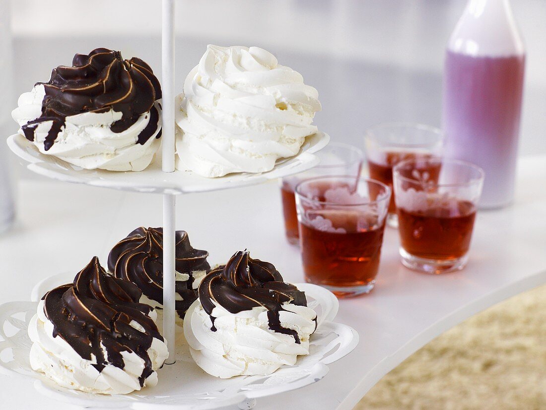 Meringues with chocolate on tiered stand