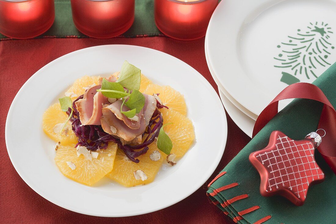 Smoked duck on red cabbage and orange slices for Christmas