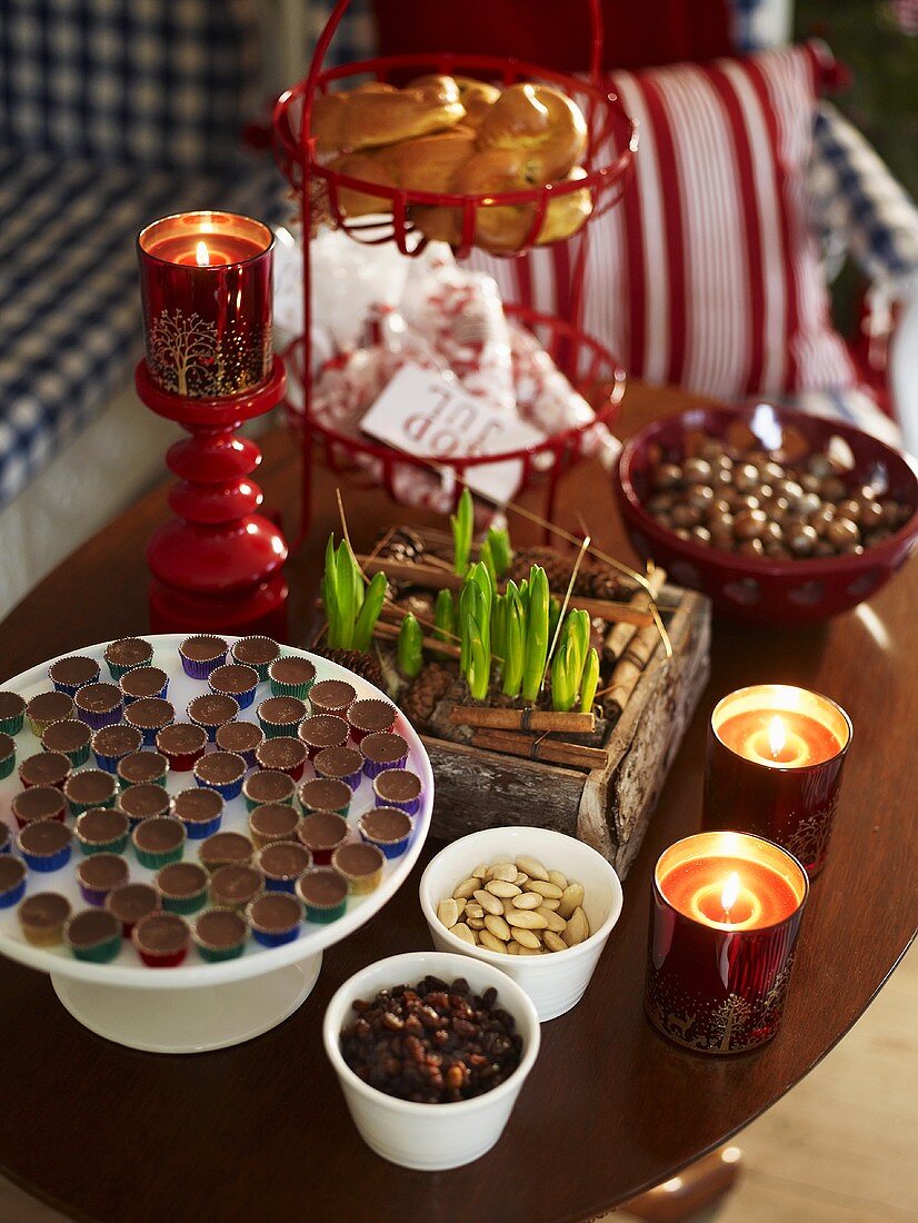 Chocolates, almonds, candles in glasses & container of bulbs