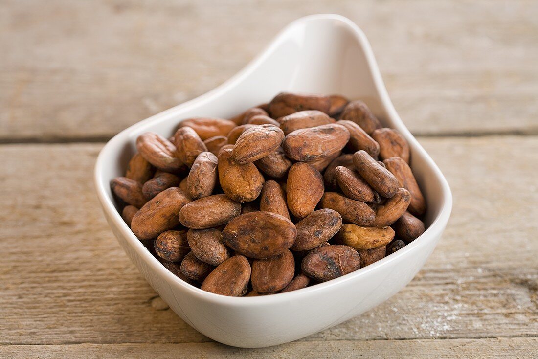 Cocoa beans in a white bowl