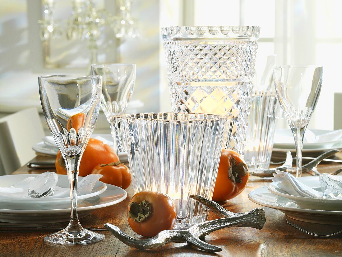 Crystal glasses and sharon fruit on Christmas table