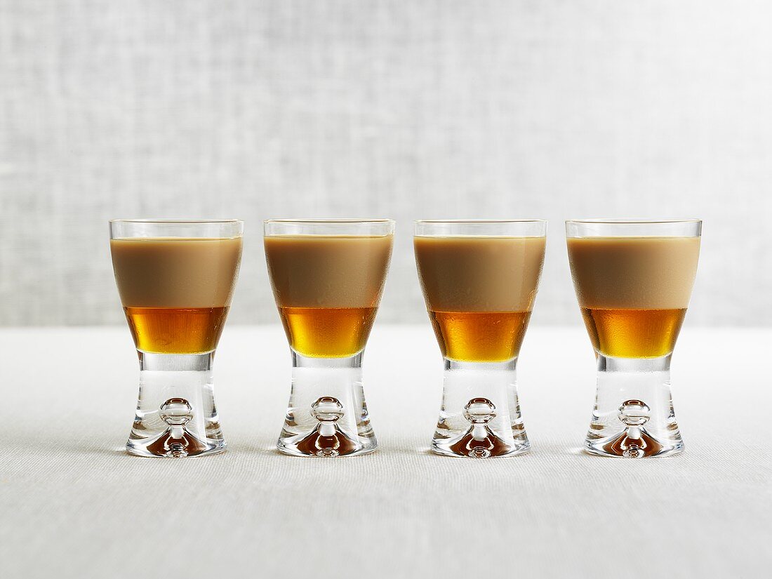 Four drinks made with Amarula & maple syrup in shot glasses