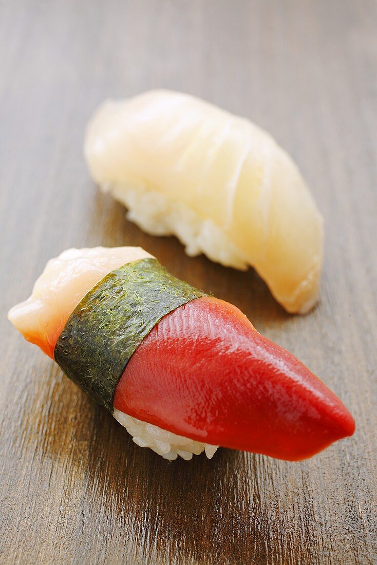 Two different nigiri sushi (shellfish and mackerel)