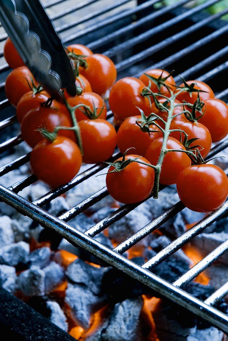 Cocktail tomatoes on a barbecue