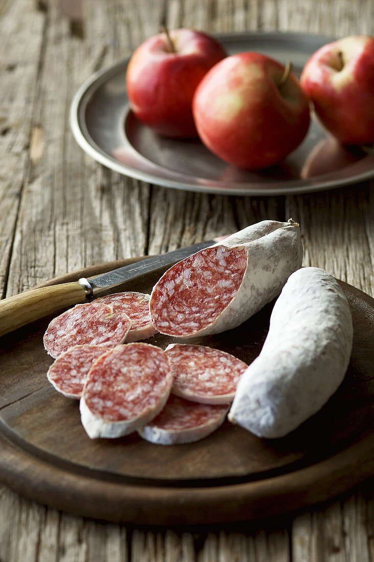 Salami, partly sliced, and apples