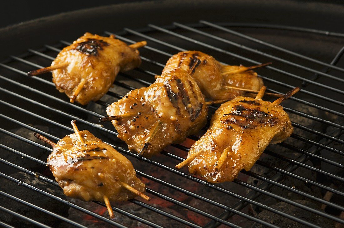 Stuffed, marinated chicken breasts on a barbecue