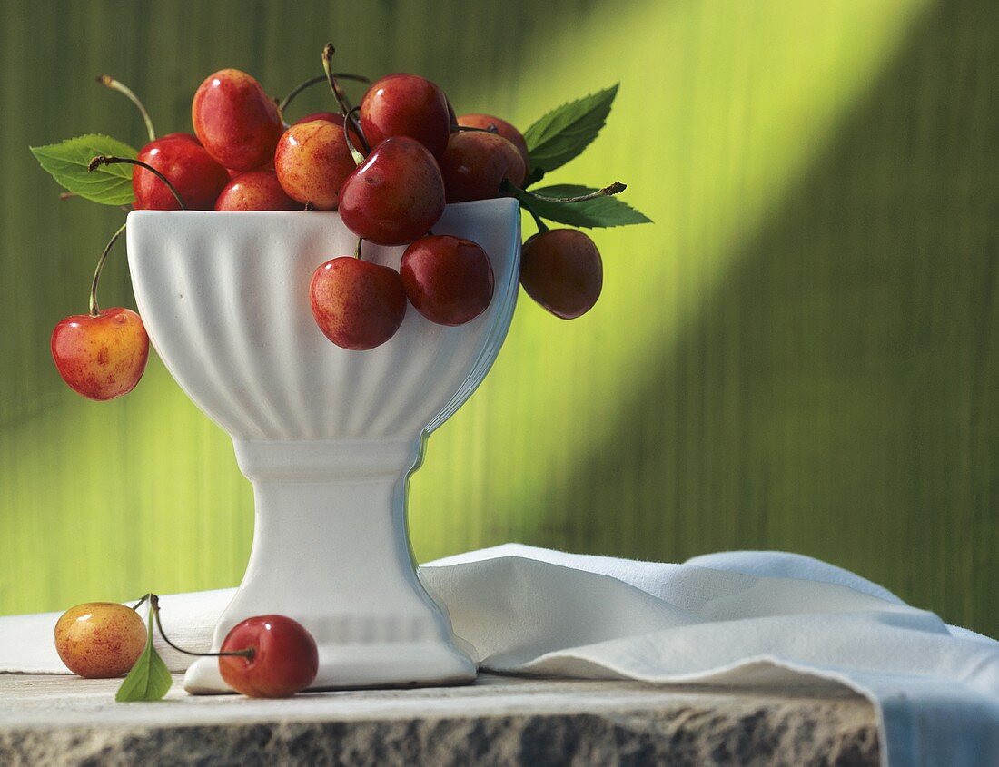 Cherries in a white pedestal bowl