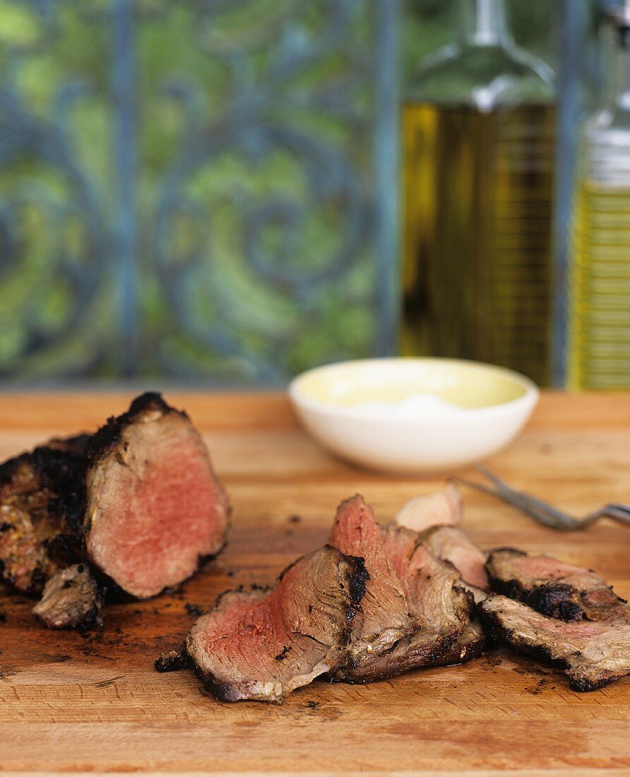 Grilled lamb on a wooden chopping board