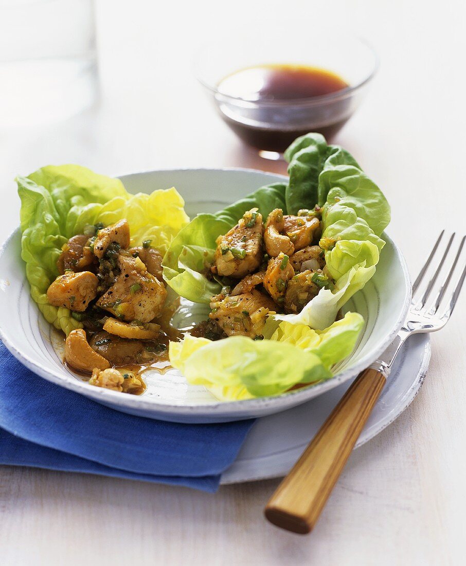 Chicken with cashew nuts on green salad