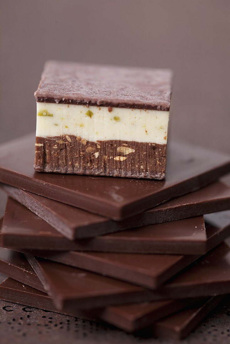 Pistachio-almond praline on squares of chocolate