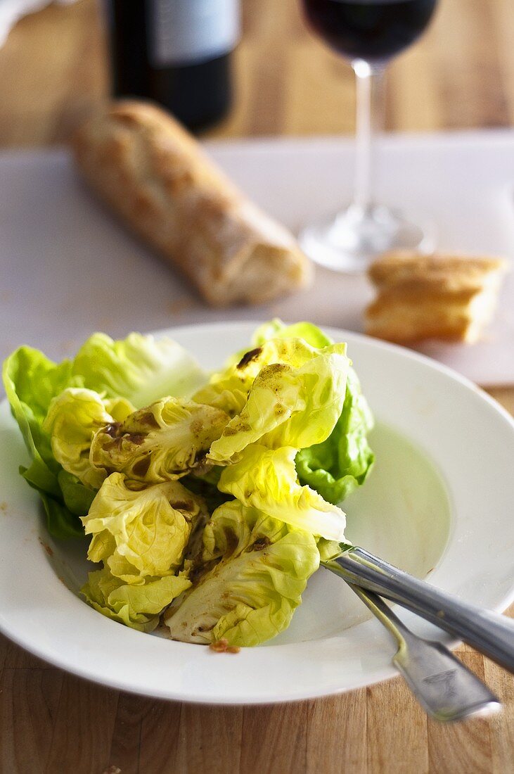 Lettuce with anchovy oil, baguette and red wine
