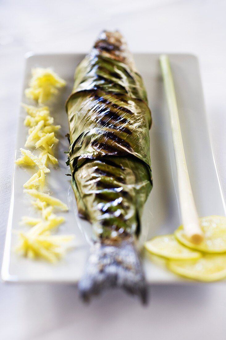 Grilled bass wrapped in banana leaves