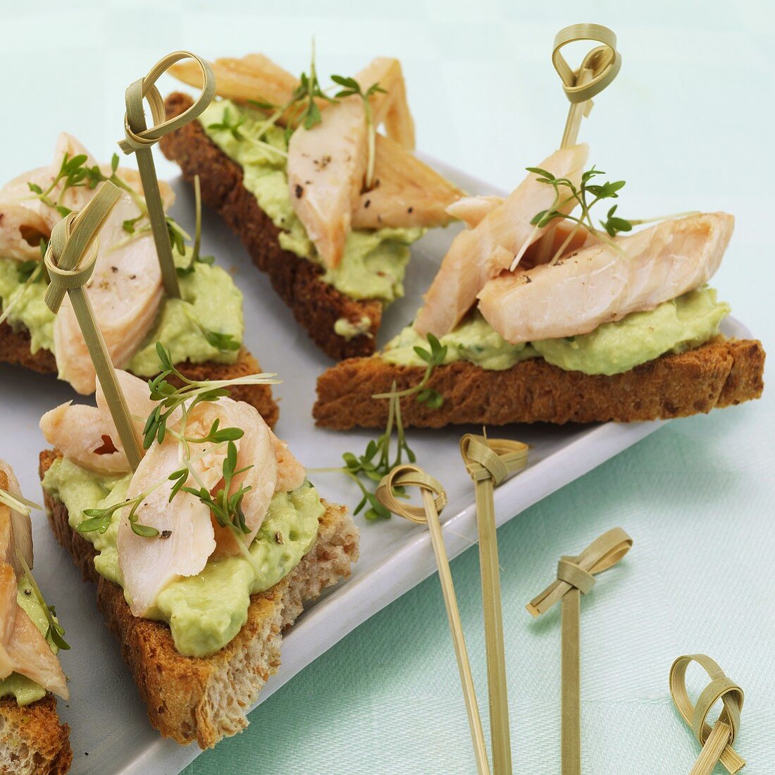 Open sandwiches with avocado cream and smoked fish