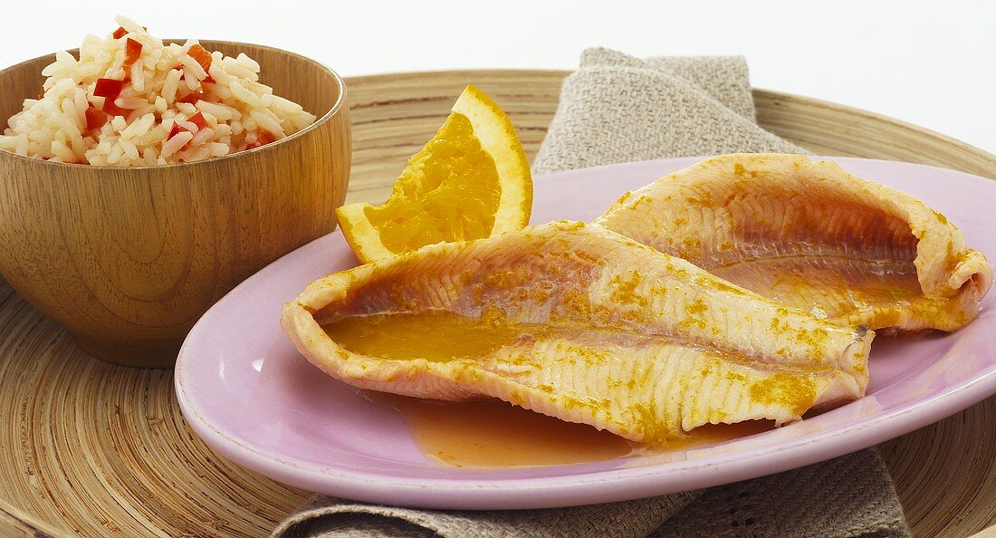Fish fillets with orange sauce and pepper rice