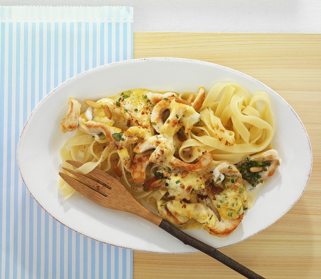 Chicken with a creamy orange sauce and tagliatelle