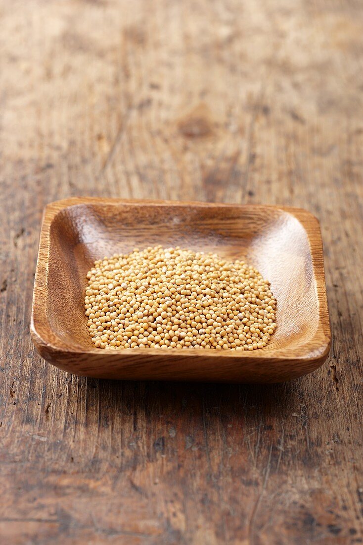 Mustard seeds in a wooden bowl