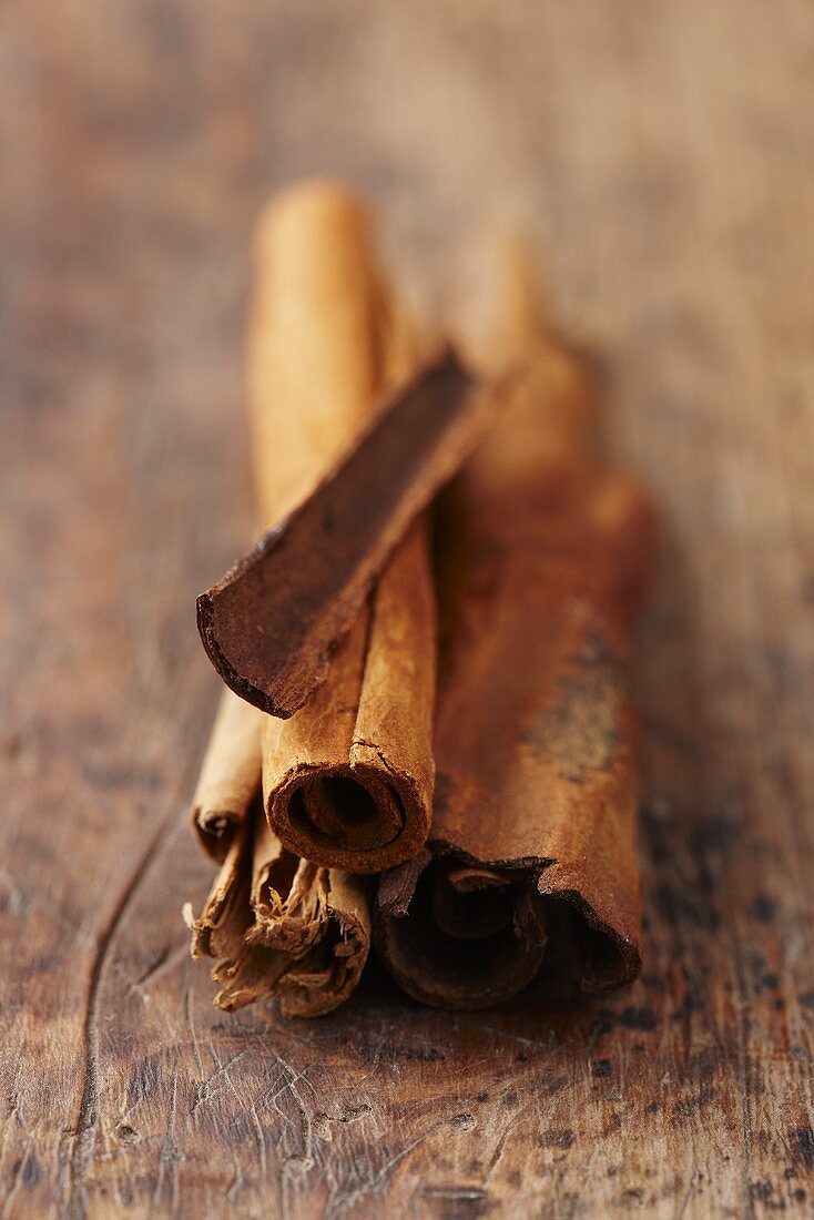 Cinnamon sticks on a wooden surface