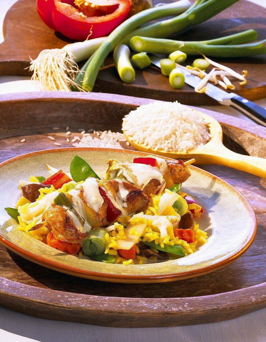 Chicken kebabs on vegetable rice