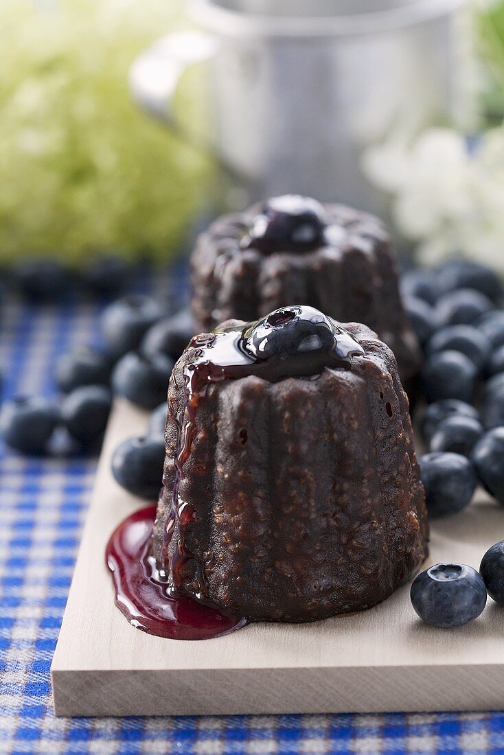 Cannelès with blueberry sauce