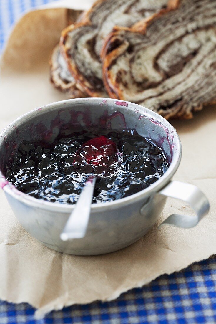 Homemade blueberry jam in a tin mug