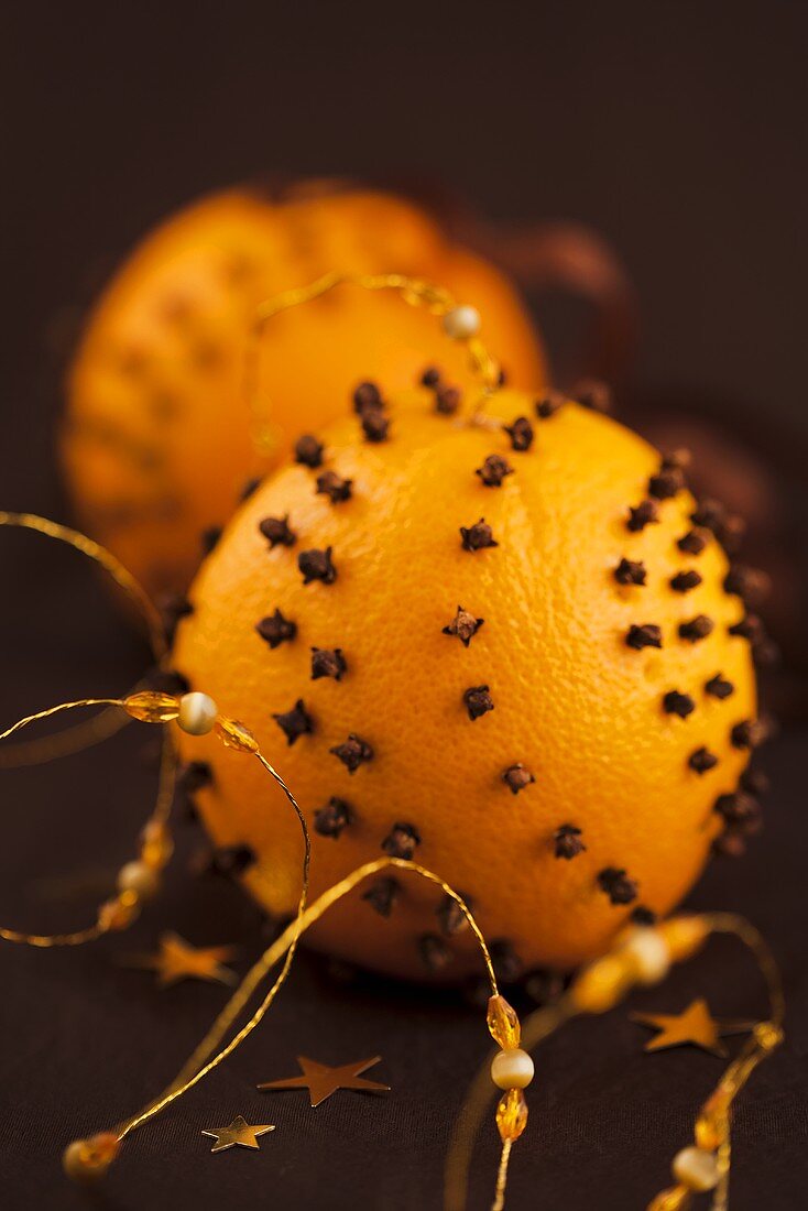 Christmas oranges pierced with cloves to hang as decoration