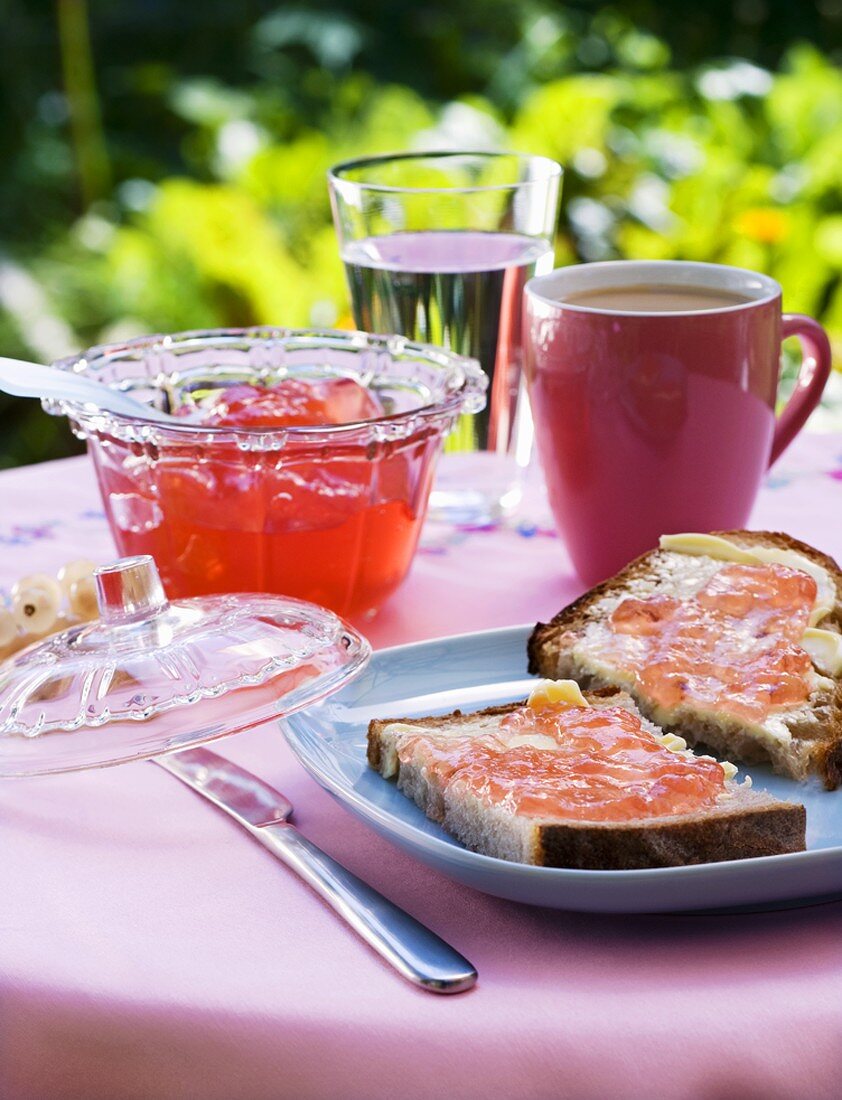Buttered bread with pink redcurrant jelly