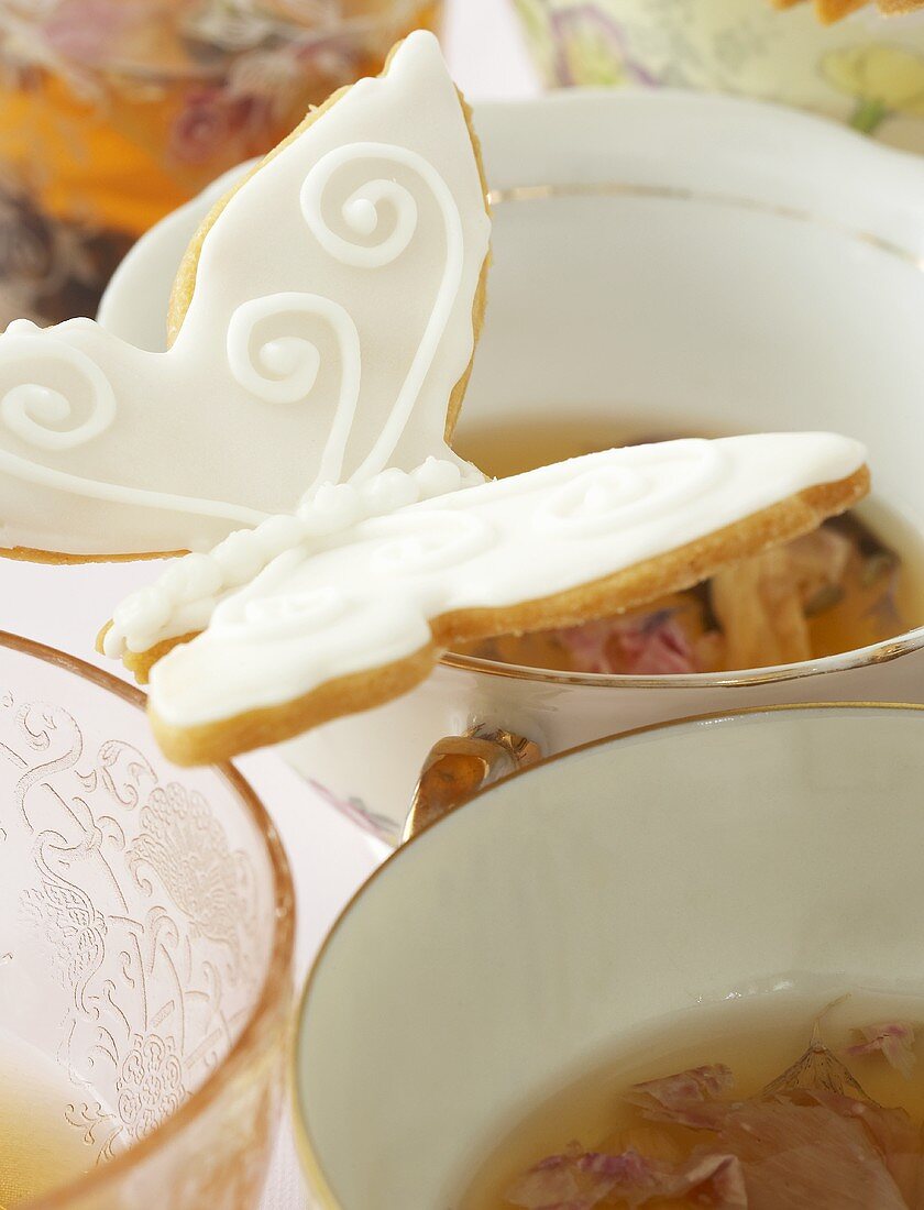 Tea cups with butterfly biscuits