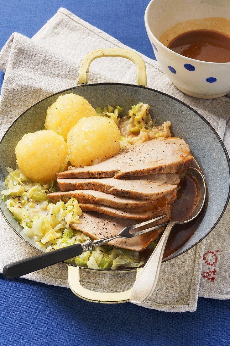 Roast pork with cabbage and potato dumplings