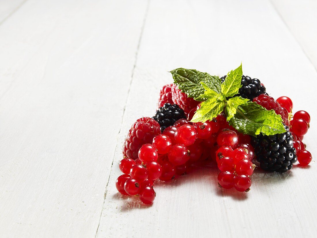 Redcurrants, blackberries and raspberries with mint leaves