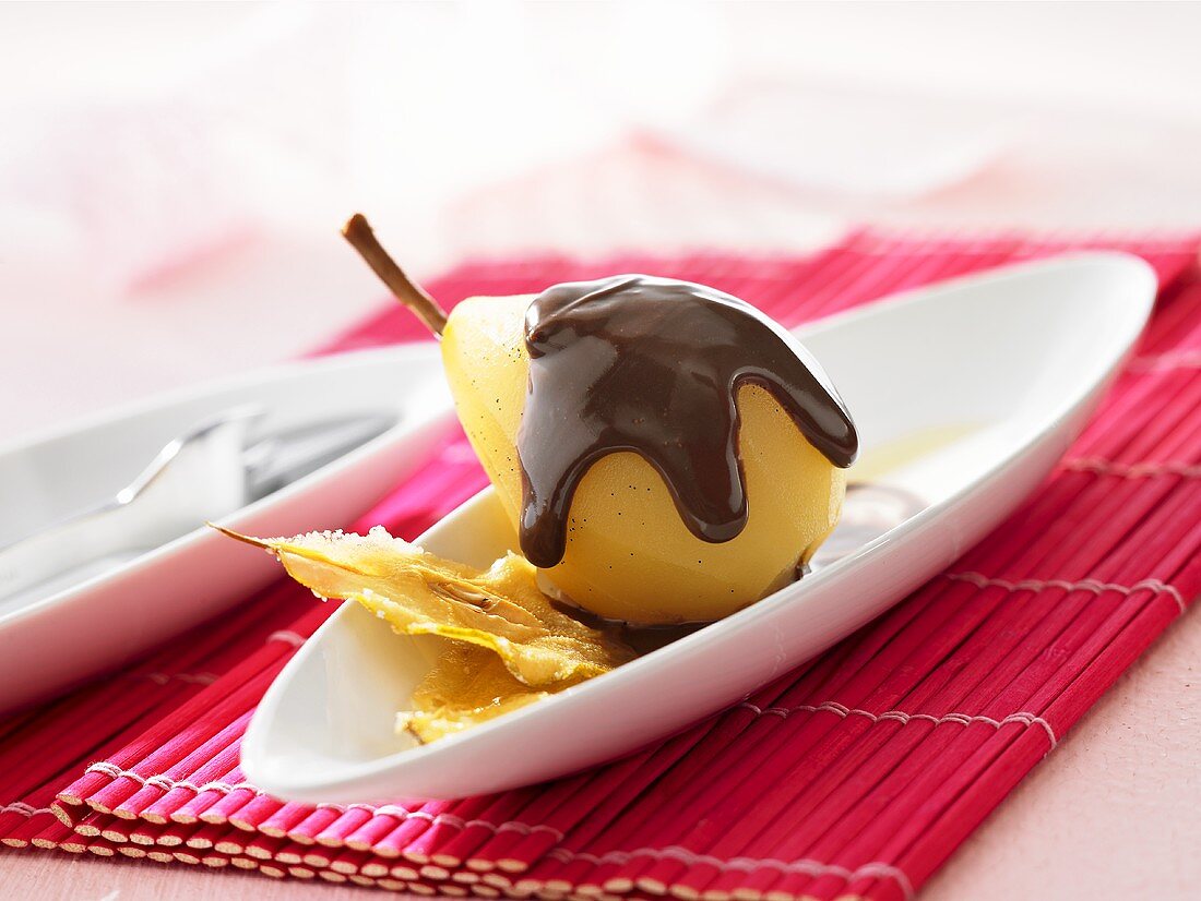 Pear in vanilla broth with chocolate sauce