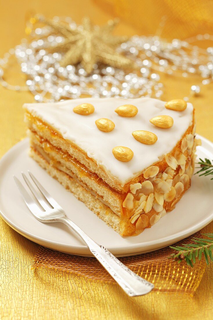 A piece of marzipan cake with orange marmalde for Christmas