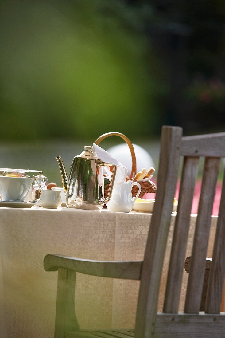 A table laid for breakfast in the garden (detail)