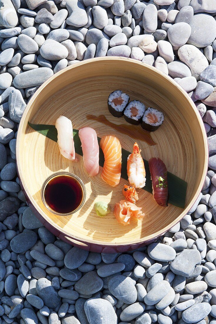 A sushi platter on gravel