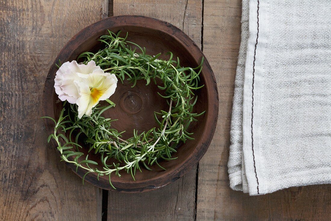 A rosemary wreath with a pansy