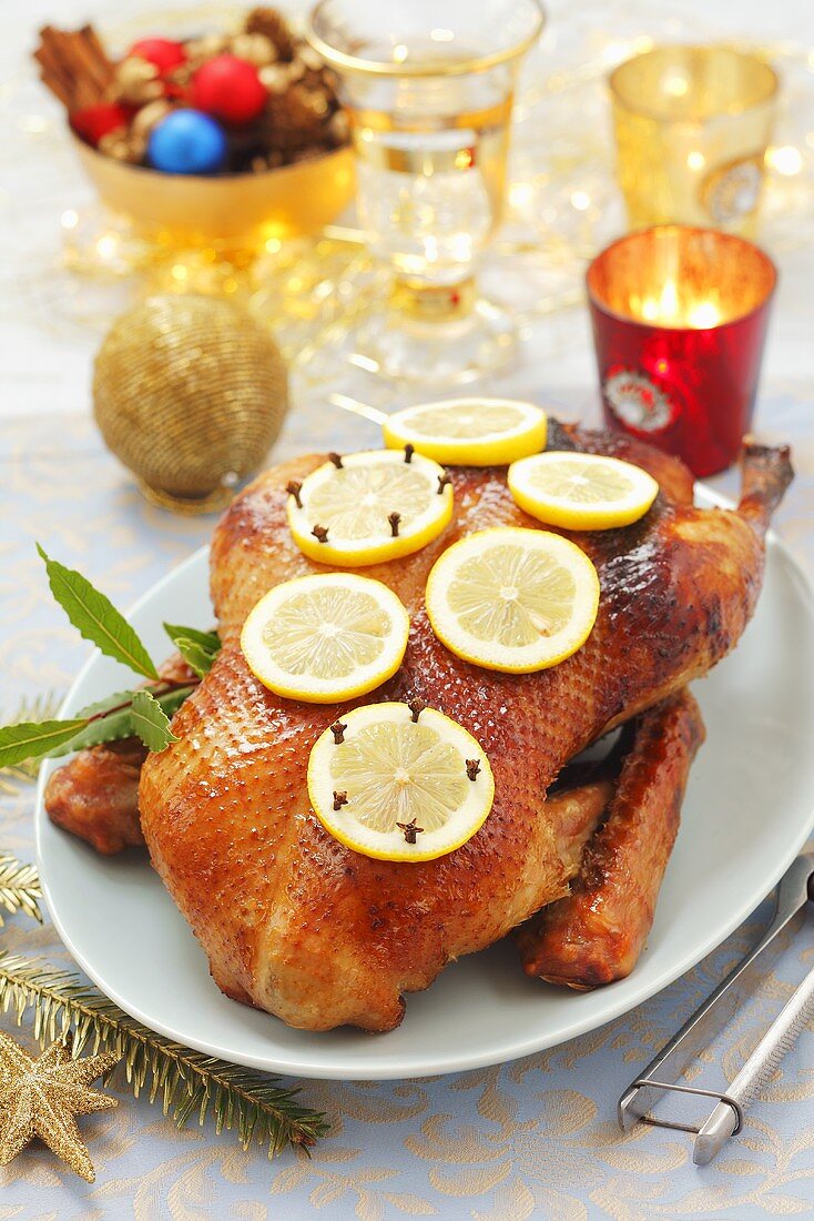 Roast duck with lemon slices and cloves