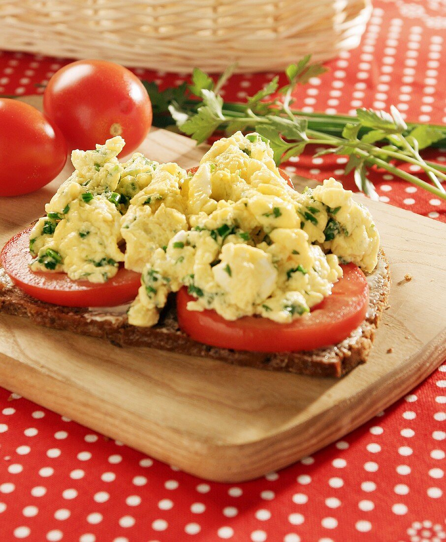 Wholemeal bread with sliced tomato and herb scrambled egg