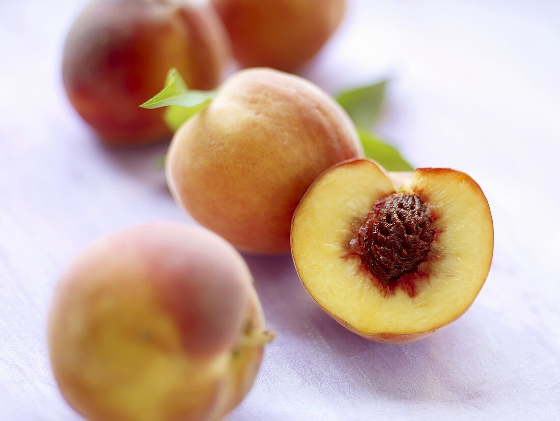 Fresh peaches, whole and halved