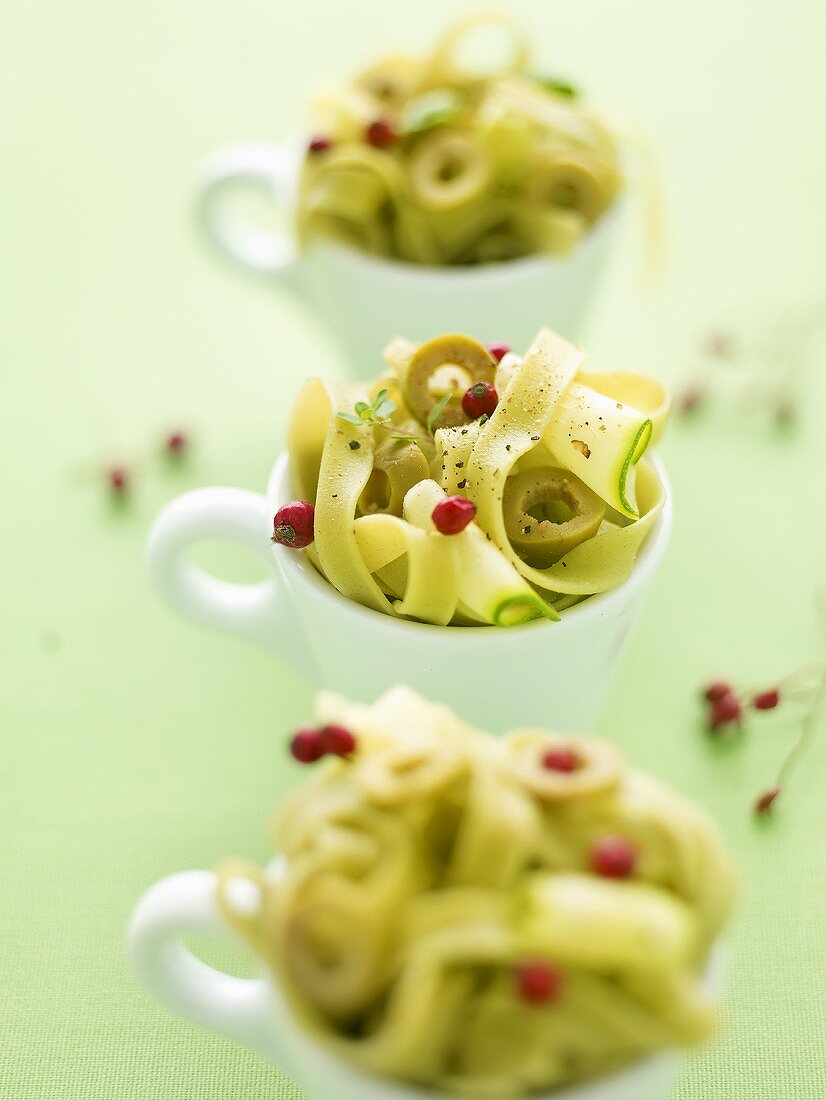 Tagliatelle with courgette, olives and rosehips in cups