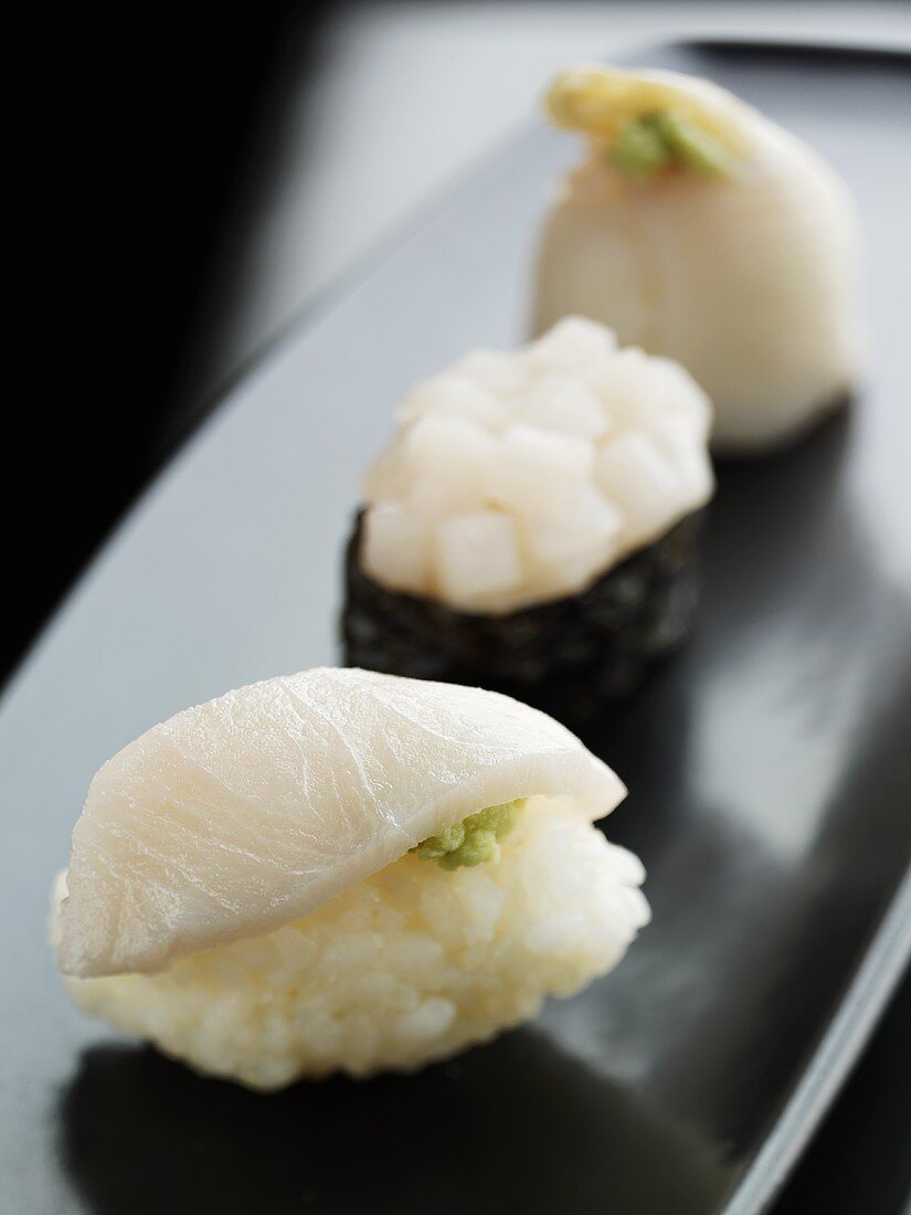 Three sushi with fish
