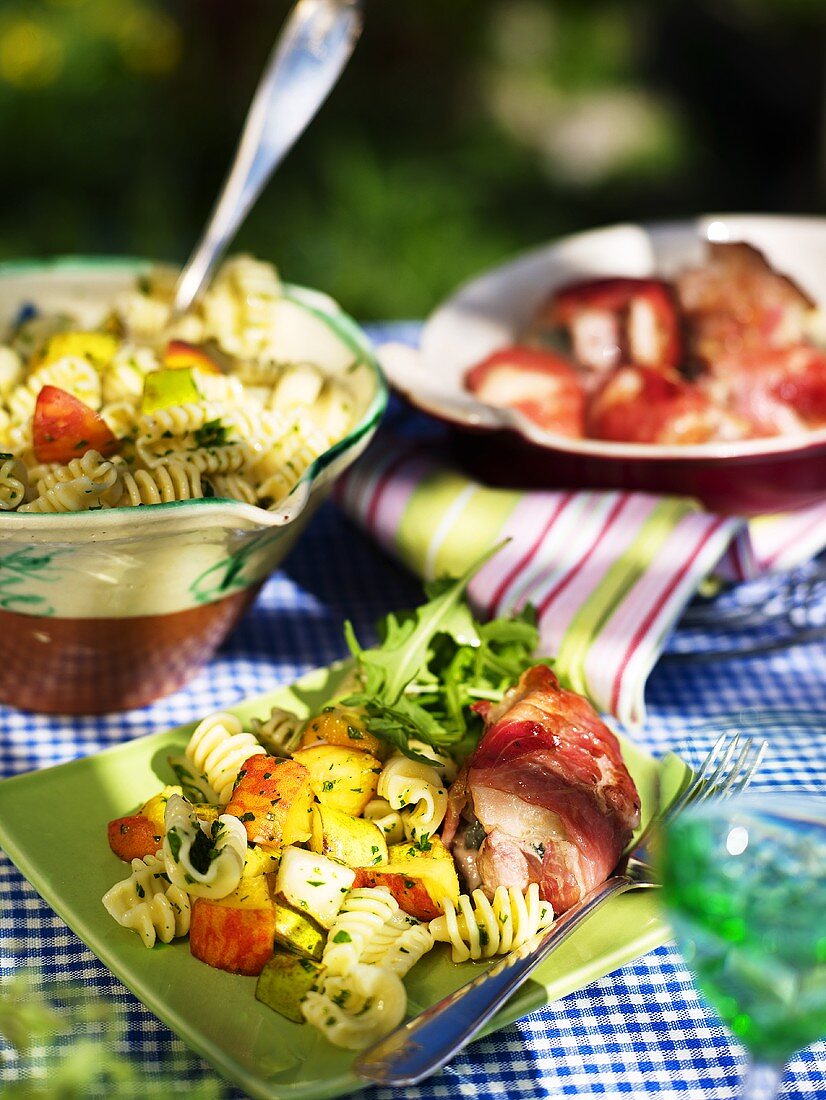 Pasta salad with fruit with chicken wrapped in bacon