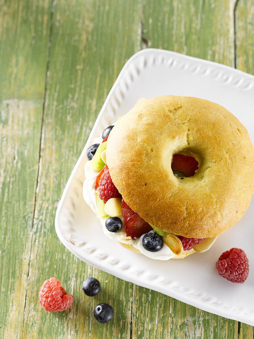 A bagel with fruit and cream, seen from above