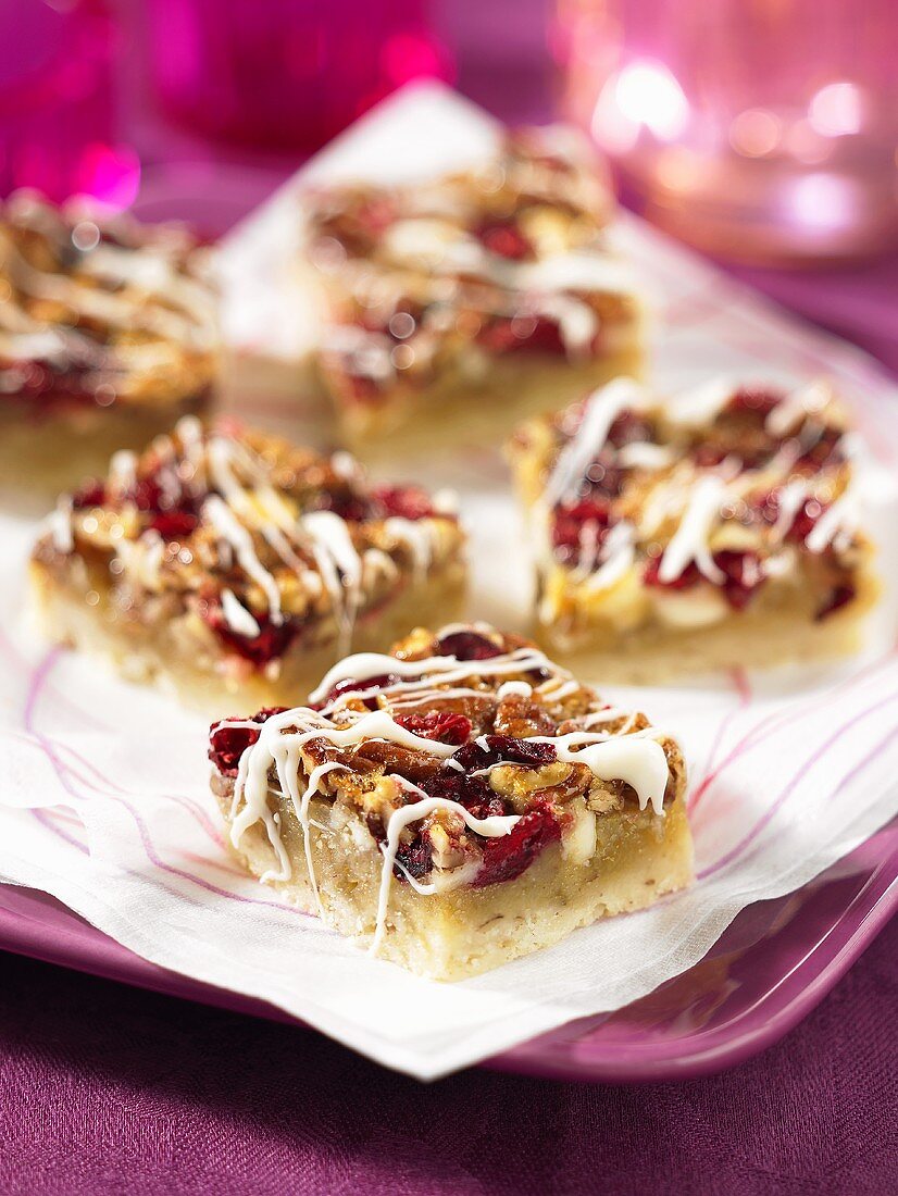 Pecan nut and cranberry slices with white chocolate glaze