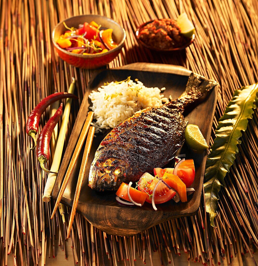 Marinated, grilled gilt-head bream with tomato salad and rice (Indonesia)