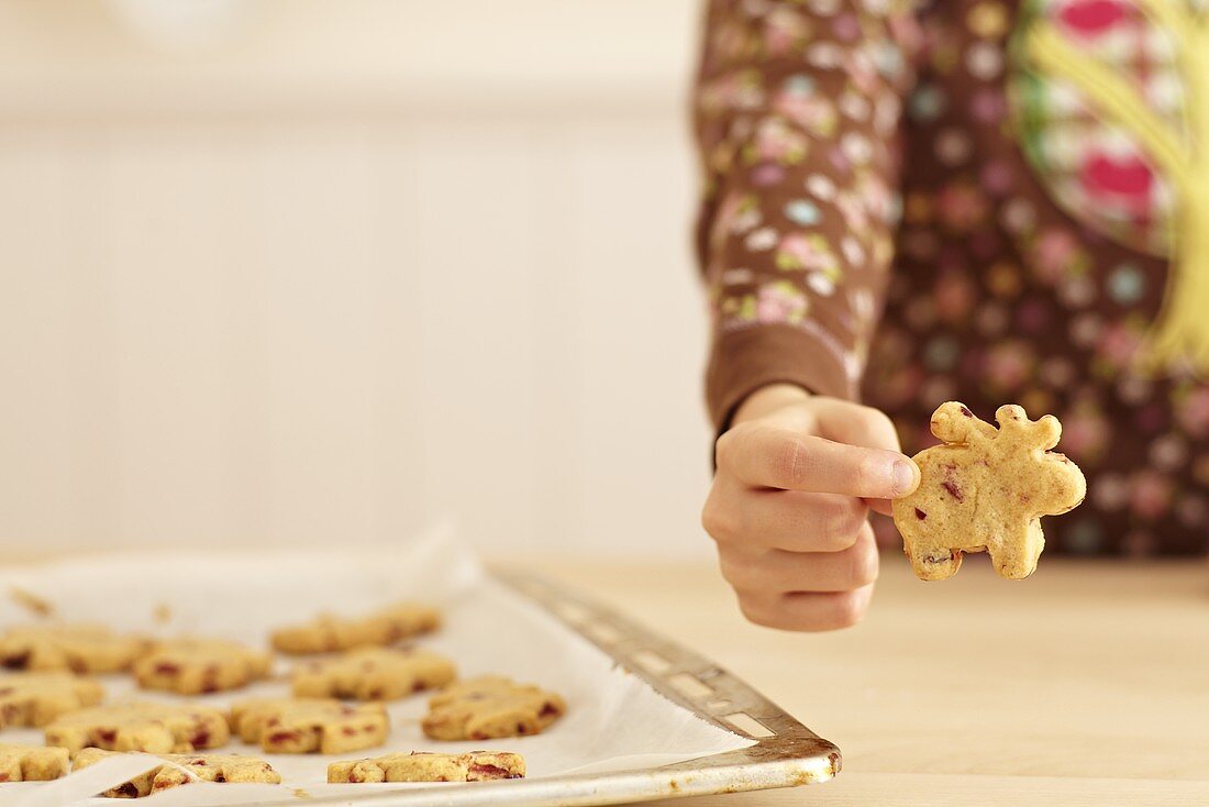 A child holding a shortbread reindeer
