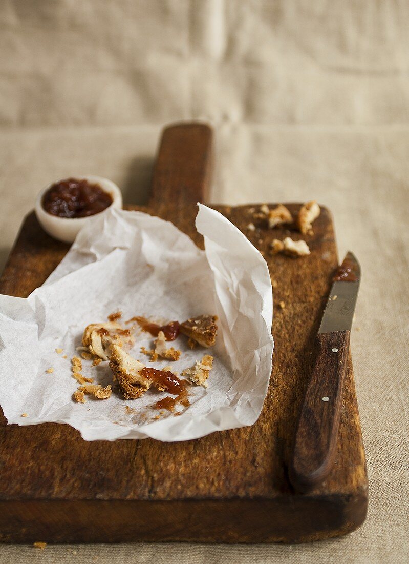 The remains of a pork pie and plum chutney on a chopping board