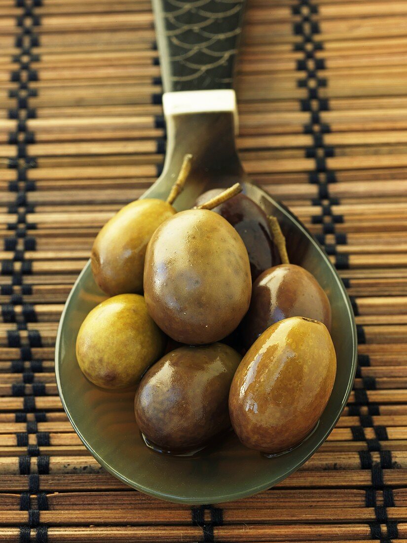 Green olives on a spoon