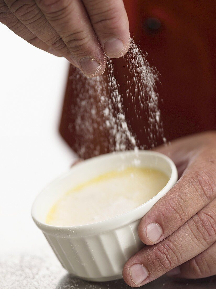 Vanilla cream being dusted with icing sugar